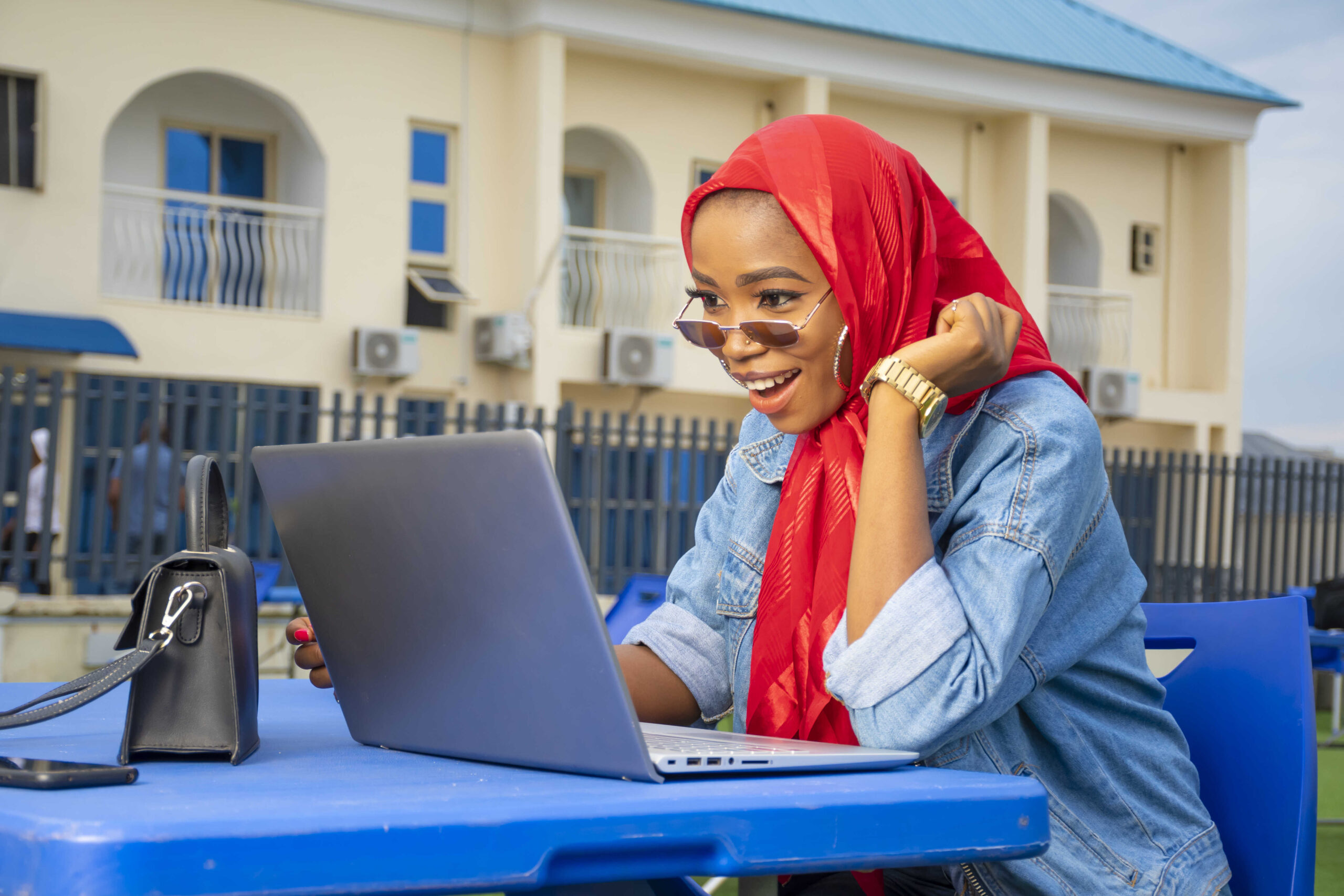 closeup-shot-pretty-young-afro-american-female-looking-excitedly-her-laptop-screen